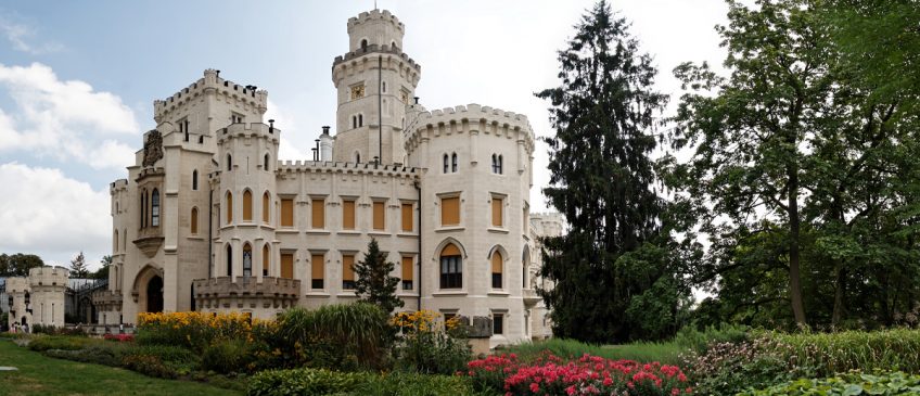 Castle set alongside trees and gardens